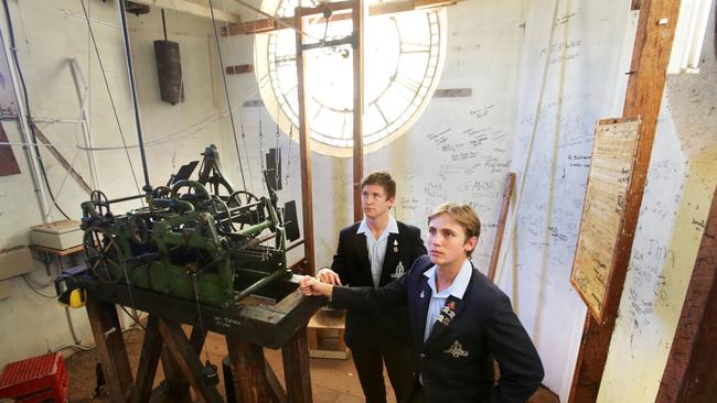 The Southport School seniors Rob Taylor and Greg Gook along with deputy-principal Alan Parsons have a rare look inside the clock tower at the school. Pic TIm Marsden