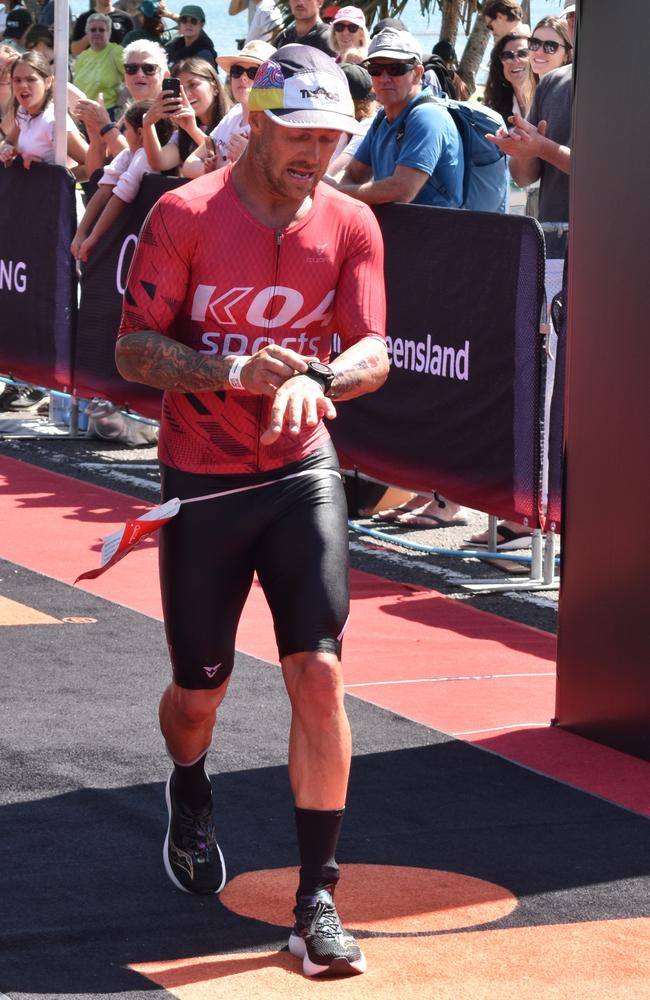 Athletes crossing the finish line at the Sunshine Coast Ironman 70.3 2023.