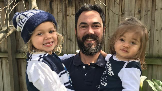 Paul Grapsas with his children Matilda and Abigail, sporting Geelong Cats kits. Photo: Supplied with permission.