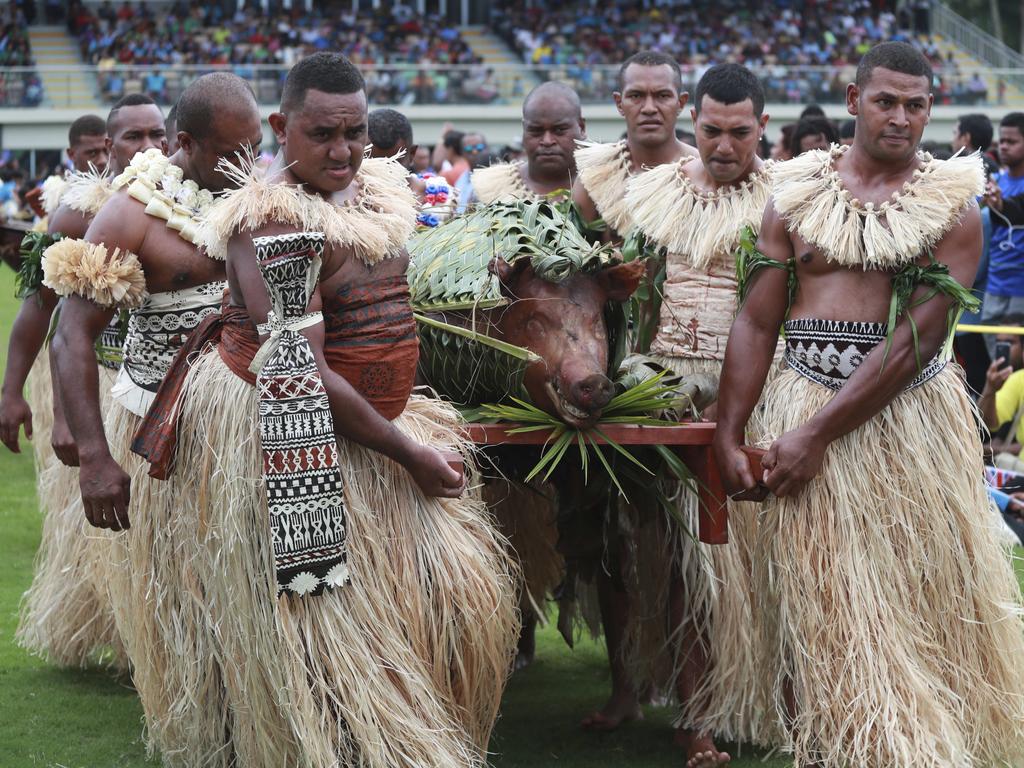 We’re guessing pork was on the menu....Traditional Fijian men carry a roasted pig in Alberts Park ahead of the royals arrival.