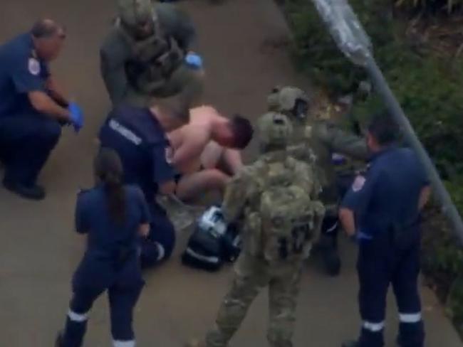 Police apprehend a man from the home in Wier Views after their dog was deployed and bit him. Picture: Seven News