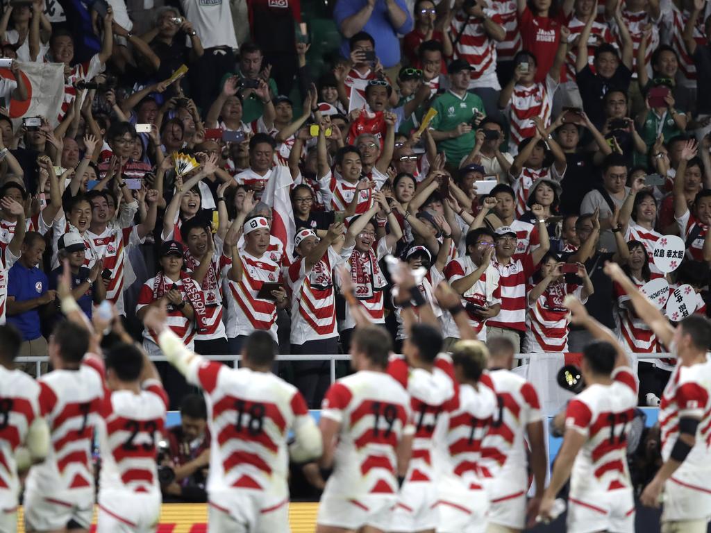 Japan team wave to their supporters after defeating Ireland 19-12.