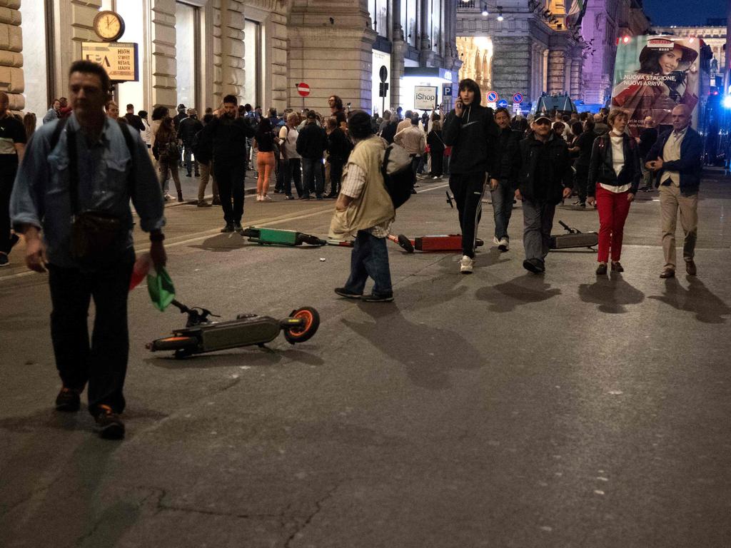 Scooters are laid on via del Corso on the sidelines of a protest against the mandatory sanitary pass in Rome. Picture: AFP