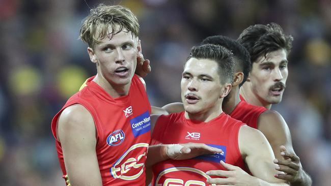 Jack Lukosius is congratulated after booting his first AFL goal.