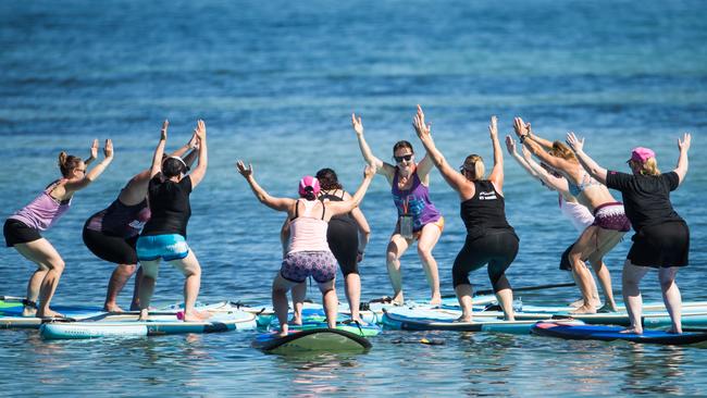 A stand-up paddle yoga class at Seacliff. Picture: Matt Loxton