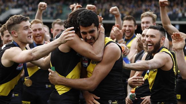 Marlion Pickett is embraced by his teammates after being called to receive his premiership medal. Picture: Ryan Pierse/AFL Media/via Getty Images.