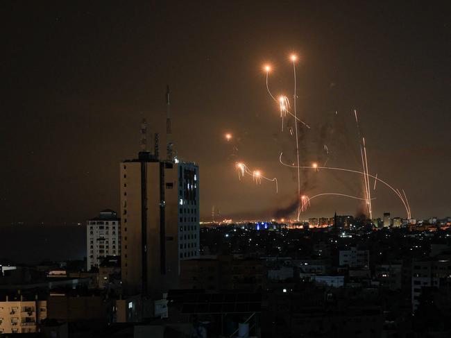 An Israeli missile launched from the Iron Dome defence missile system attempts to intercept a rocket, fired from the Gaza Strip, over the city of Netivot in southern Israel. Picture: AFP