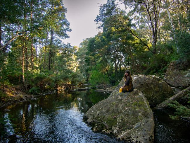 A guest enjoys the Kombi Kamp’s peaceful creekside setting. Picture: Harriet Paul Photography