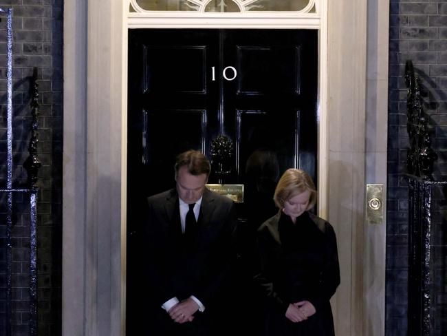 British PM Liz Truss and her husband Hugh O'Leary stand on the steps of 10 Downing Street joining in a National Moment of reflection to show her respect to the late Queen. Picture: Getty Images.