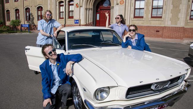 Loyola College students Aden, Jack, Larissa and Simone with a 1966 Ford Mustang. Picture: Andy Brownbill