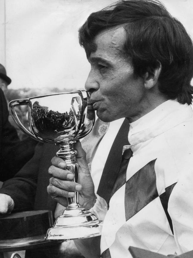 Jockey Frank Reys kisses the Melbourne Cup trophy he won for Pat Curtain, owner of racehorse "Gala Supreme", in the Melbourne Cup race at Flemington Racecourse, November 6, 1973. (Pic by unidentified staff photographer)