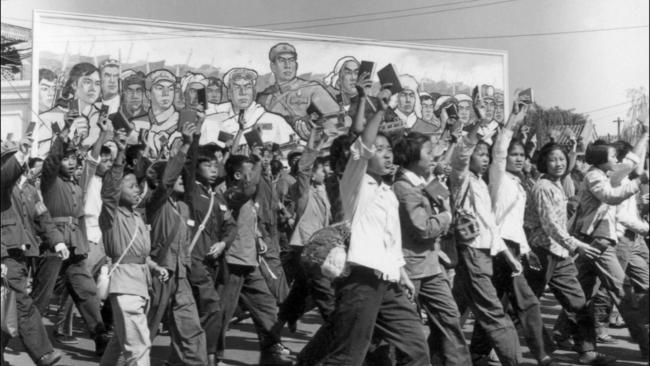 Red Guards, high school and university students, waving copies of Chairman Mao Zedong's Little Red Book as they parade in Beijing's streets in 1966.