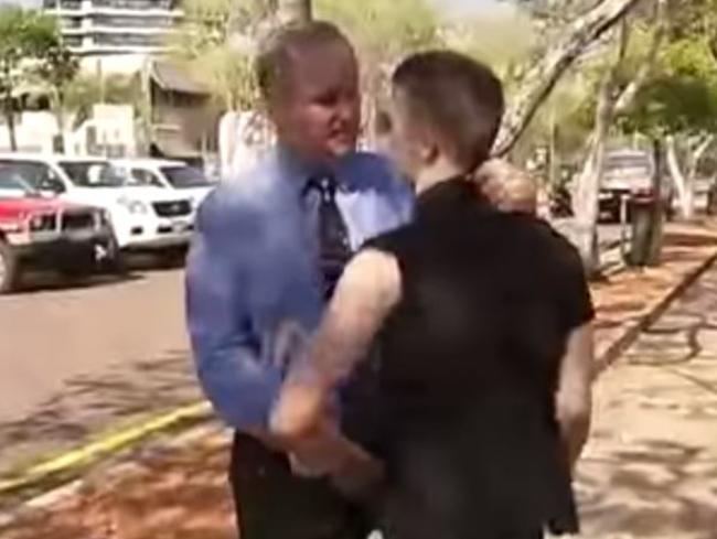 The man known as ‘Elf’ tries to make a citizens arrest during a press conference. Yes, these things actually happen in Darwin.