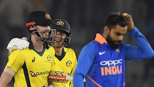 Ashton Turner (L) is congratulated by Jhye Richardson (C) after spearheading Australia’s game four victory. Picture: AFP