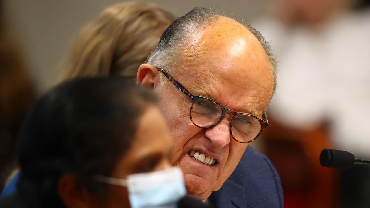 President Donald Trump's personal lawyer Rudy Giuliani listens to Detroit poll worker Jessi Jacobs during an appearance before the Michigan House Oversight Committee. Picture: AFP