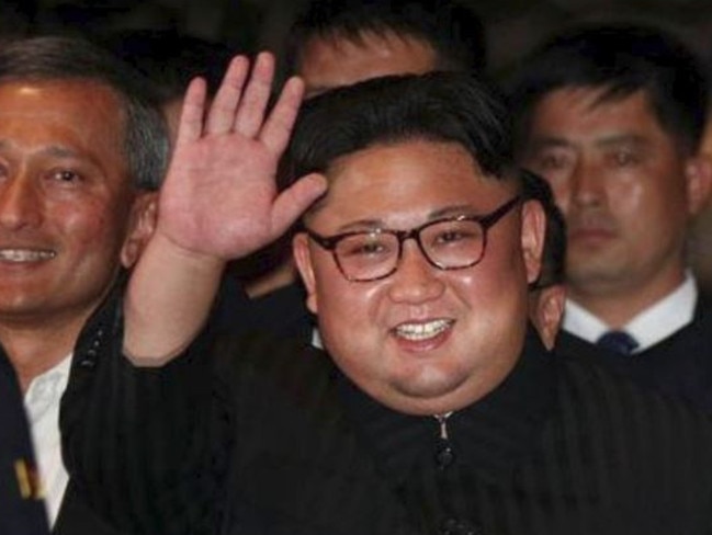 Kim Jong-un greets onlooks after he arrived at a Singapore hotel. Picture: Reuters