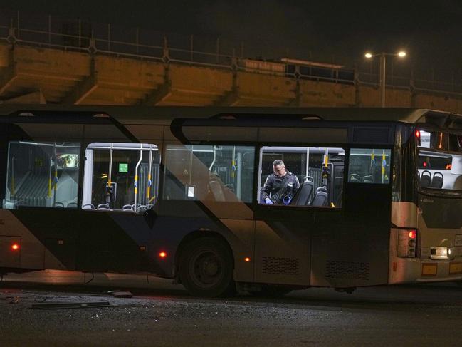 An Israeli police officer inspect the scene where police have reported a series of explosions on buses in Bat Yam, central Israel. Picture: AP