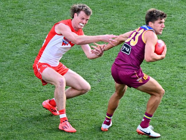 MELBOURNE, AUSTRALIA - SEPTEMBER 28: Zac Bailey of the Lions is tackled by Nick Blakey of the Swans during the AFL Grand Final match between Sydney Swans and Brisbane Lions at Melbourne Cricket Ground, on September 28, 2024, in Melbourne, Australia. (Photo by Josh Chadwick/AFL Photos/Getty Images)