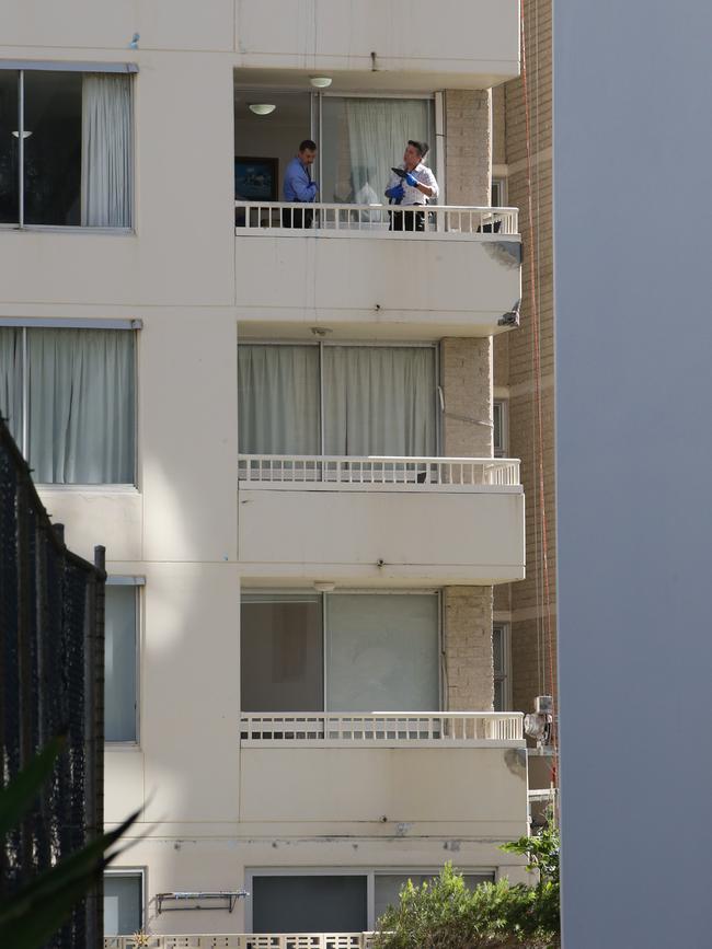 Police on a balcony of the View Pacific Resort as they investigate the alleged murder. Picture: Glenn Hampson