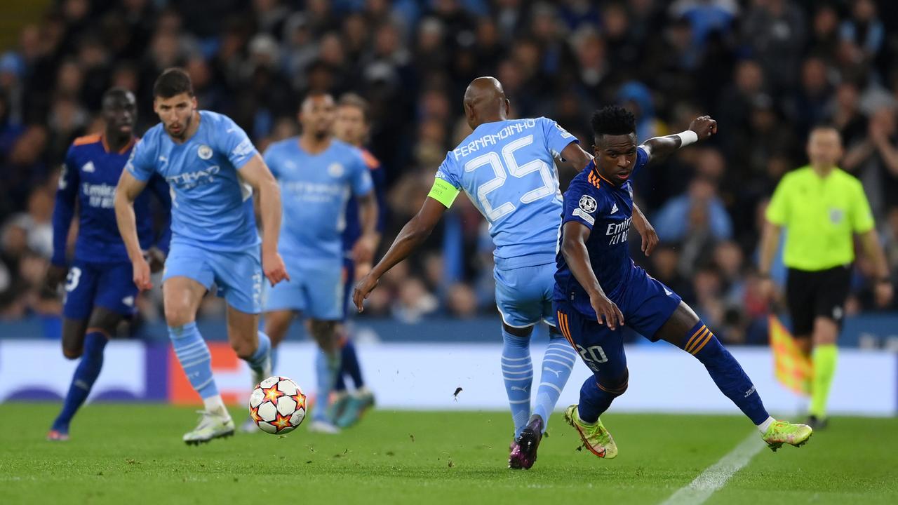 Vinicius Junior of Real Madrid runs ahead of Fernandinho of Manchester City leading to a goal during the UEFA Champions League Semi Final Leg One match between Manchester City and Real Madrid at Etihad Stadium on April 26, 2022 in Manchester, England. (Photo by David Ramos/Getty Images)