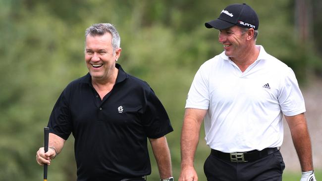 Keen golfer Barnes with his Australian champion mate Peter Lonard at a pro-am tournament. Picture: Phil Hillyard