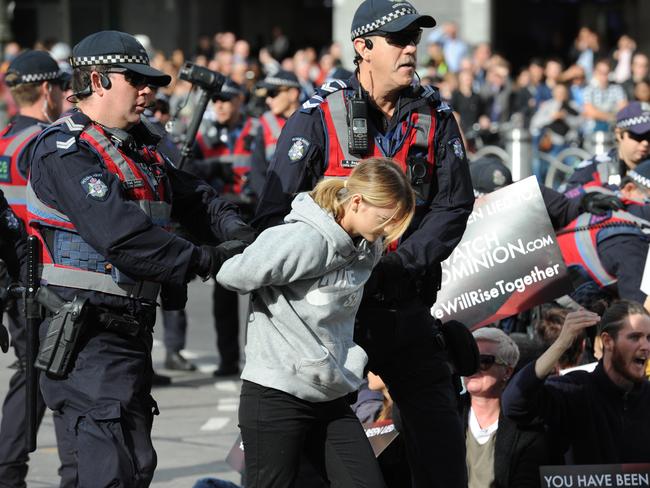 Police move in to remove vegan protestors who had been blocking the intersection of Flinders and Swanston Street Melbourne in support of animal rights. Picture: Andrew Henshaw