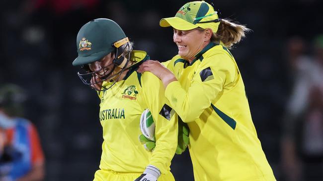 Alyssa Healy and Meg Lanning celebrate yet another world title.