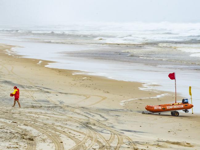 Beach closed flags up at Coolum Beach as heavy rain, strong winds and marine warnings are put in place on Easter Monday. Photo Lachie Millard