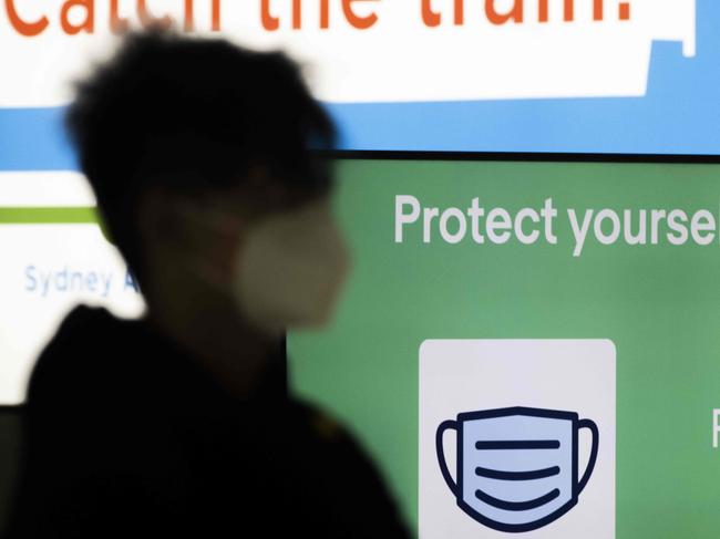 SYDNEY, AUSTRALIA - NewsWire Photos FEBRUARY 14, 2021: A 'please wear a mask' sign is seen in the baggage claim area at Sydney Domestic airport. Picture: NCA NewsWire / Jenny Evans