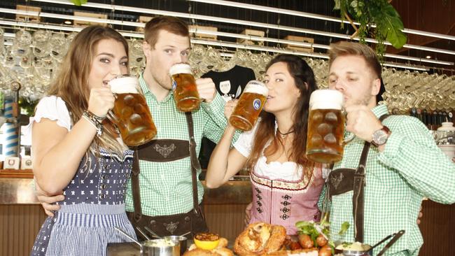 All set fro Oktoberfest at The Bavarian Bier Cafe at Broadbeach are this multicultural group of beer lovers Holly Britton from Canada, Rory Stien from Australia, Marina Rosa from Brazil, and Simon Nolin from Sweden.