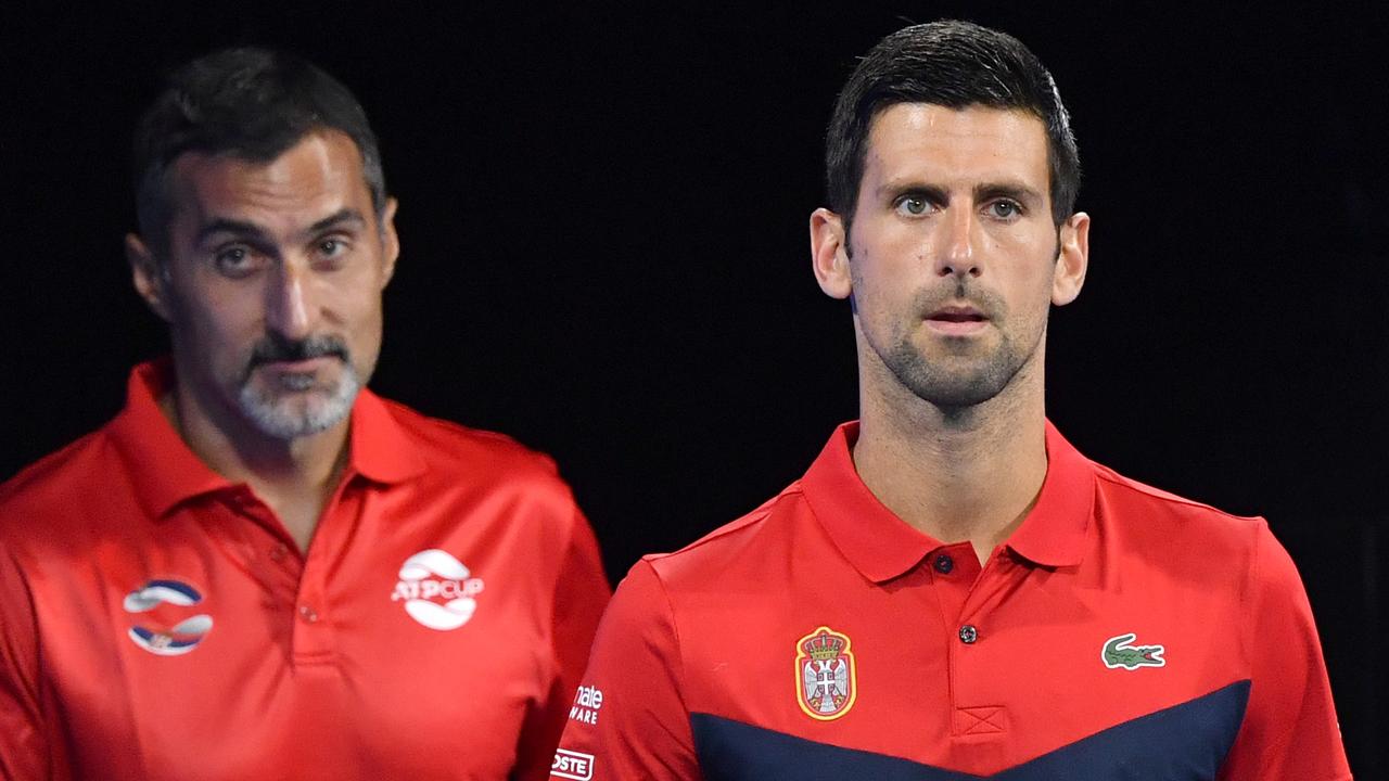 Serbia team captain Nenad Zimonjic (left) and Novak Djokovic (right) of Serbia are seen walking out onto the court for his match against Gael Monfils of France during day 4 of the ATP Cup tennis tournament at Pat Rafter Arena in Brisbane, Monday, January 6, 2020. (AAP Image/Darren England) NO ARCHIVING, EDITORIAL USE ONLY