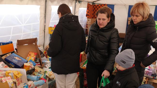 Women and children who said they fled from nearby Yavoriv in Ukraine stock up on donated food. It comes as the Ukraine crisis compounds existing global supply chain issues. Picture: Sean Gallup