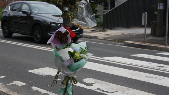 Flowers left at the crossing on the intersection of Frederick St and John St after an 87-year-old man was hit and killed. Picture: Alexi Demetriadi