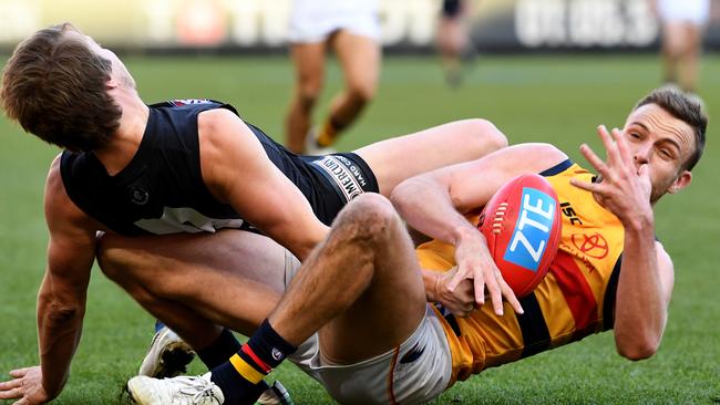 Brodie Smith of the Crows wins the ball against Liam Sumner of the Blues. Picture: Joe Castro (AAP)