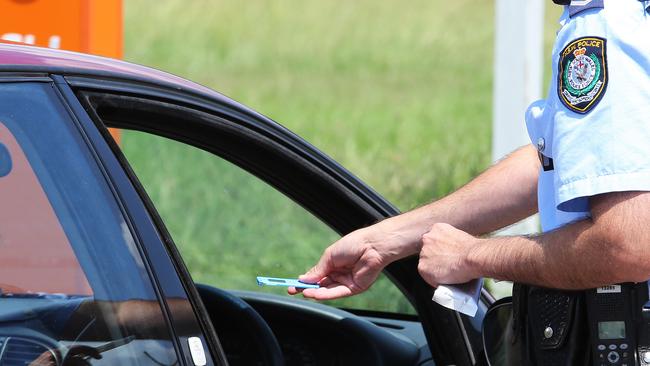 A police officer conducts a roadside drug test.