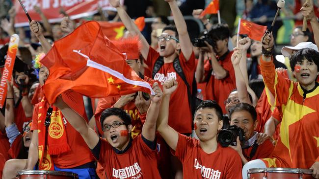 Fans of China cheer during their Group B football match against North Korea.