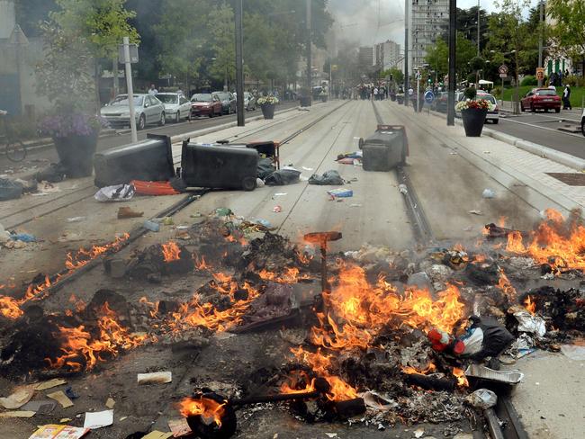 Burning detritus seen along the tramway line in Sarcelles. AFP PHOTO / PIERRE ANDRIEU