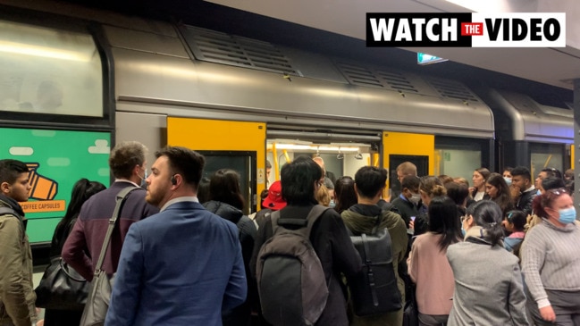 People push their way into overcrowded carriages at Town Hall train station on Wednesday evening