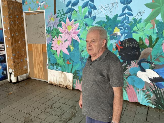 By Gone Barber owner France Linzmoyer stands in front of graffiti covered the wall at the former-Dimmeys Arcade. Picture: Leighton Smith.