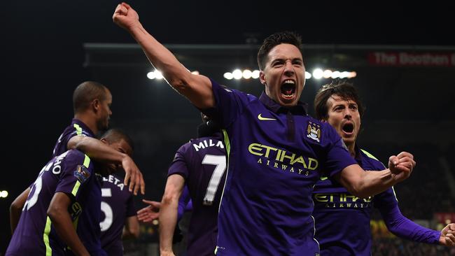 Manchester City's French midfielder Samir Nasri enjoys James Milner’s goal.