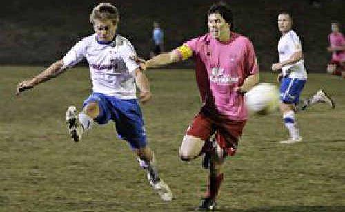 Woombye clears the ball under pressure. Picture: Cade Mooney