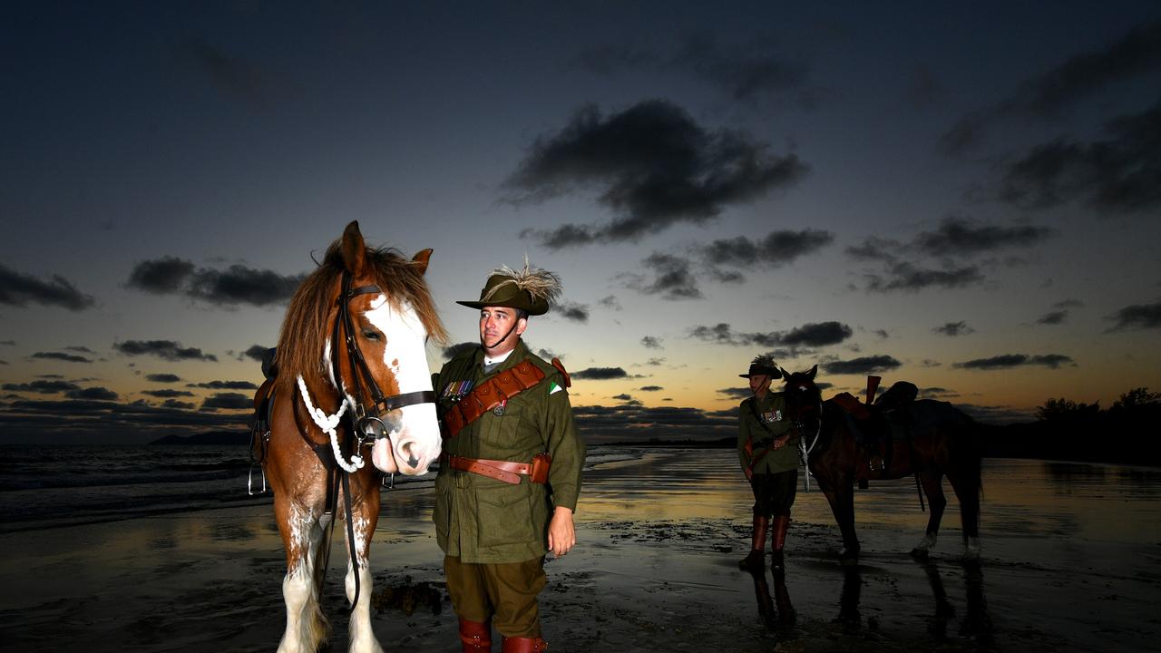 Veteran Jason Mengel with Gabriel and his dad Vietnam Veteran Lester Mengel from the 27th Lighthorse Regiment with Sox at dawn at Saunders Beach will be on parade for Remembrance Day. Picture: Evan Morgan