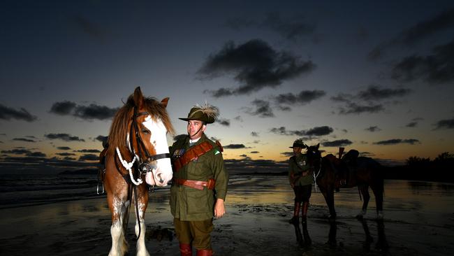 Veteran Jason Mengel with Gabriel and his dad Vietnam Veteran Lester Mengel from the 27th Lighthorse Regiment with Sox at dawn at Saunders Beach will be on parade for Remembrance Day. Picture: Evan Morgan