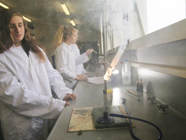 File image: Students conducting experiments in the chemistry lab, igniting potassium chloride in a test tube. Picture: Mathew Farrell