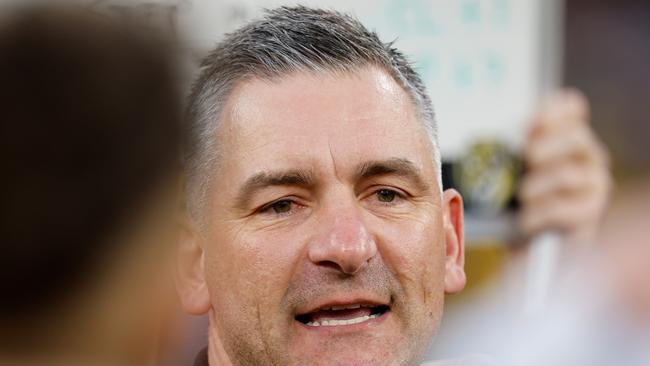 MELBOURNE, AUSTRALIA - AUGUST 24: Adem Yze, Senior Coach of the Tigers addresses his players during the 2024 AFL Round 24 match between the Richmond Tigers and the Gold Coast SUNS at The Melbourne Cricket Ground on August 24, 2024 in Melbourne, Australia. (Photo by Dylan Burns/AFL Photos via Getty Images)