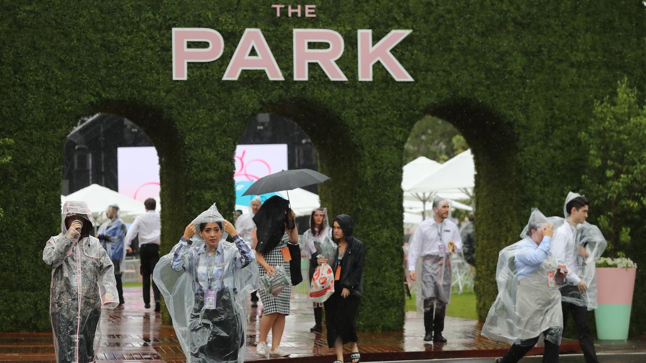 Crowds arrive in the wet weather at Flemington. Picture: Alex Coppel