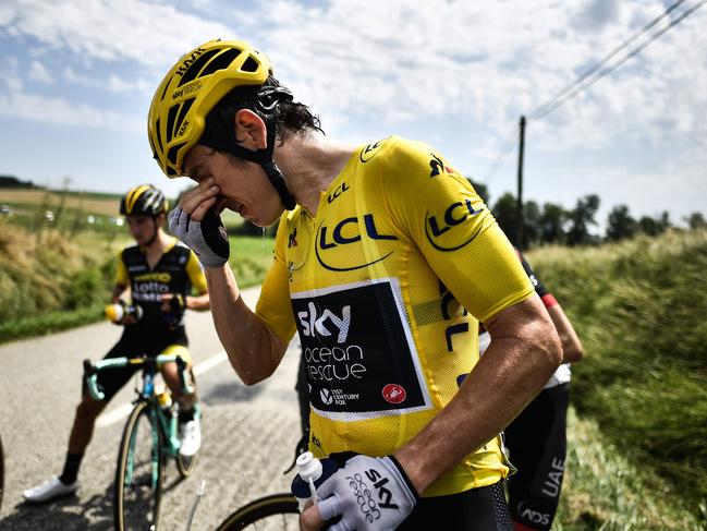 Great Britain's Geraint Thomas cleans his eyes after tear gas was used.