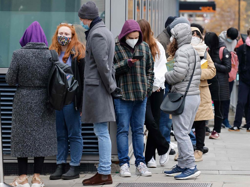 People wait in a queue outside University College London Hospital vaccination centre to receive their the Covid-19 vaccine or booster in London. Picture: AFP