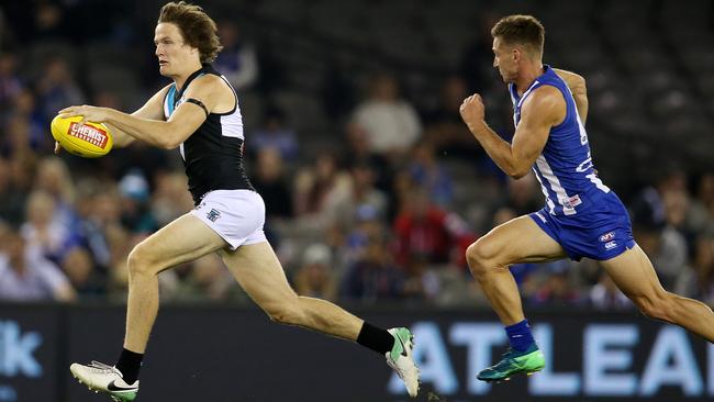 Port Adelaide’s Jared Polec bursts clear of North Melbourne’s Shaun Atley at Etihad Stadium last week. Picture: Michael Klein.