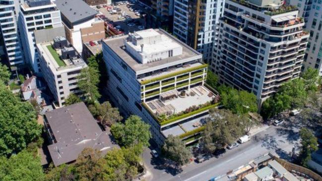 A photo of the building (centre, front) where the new school would be located.